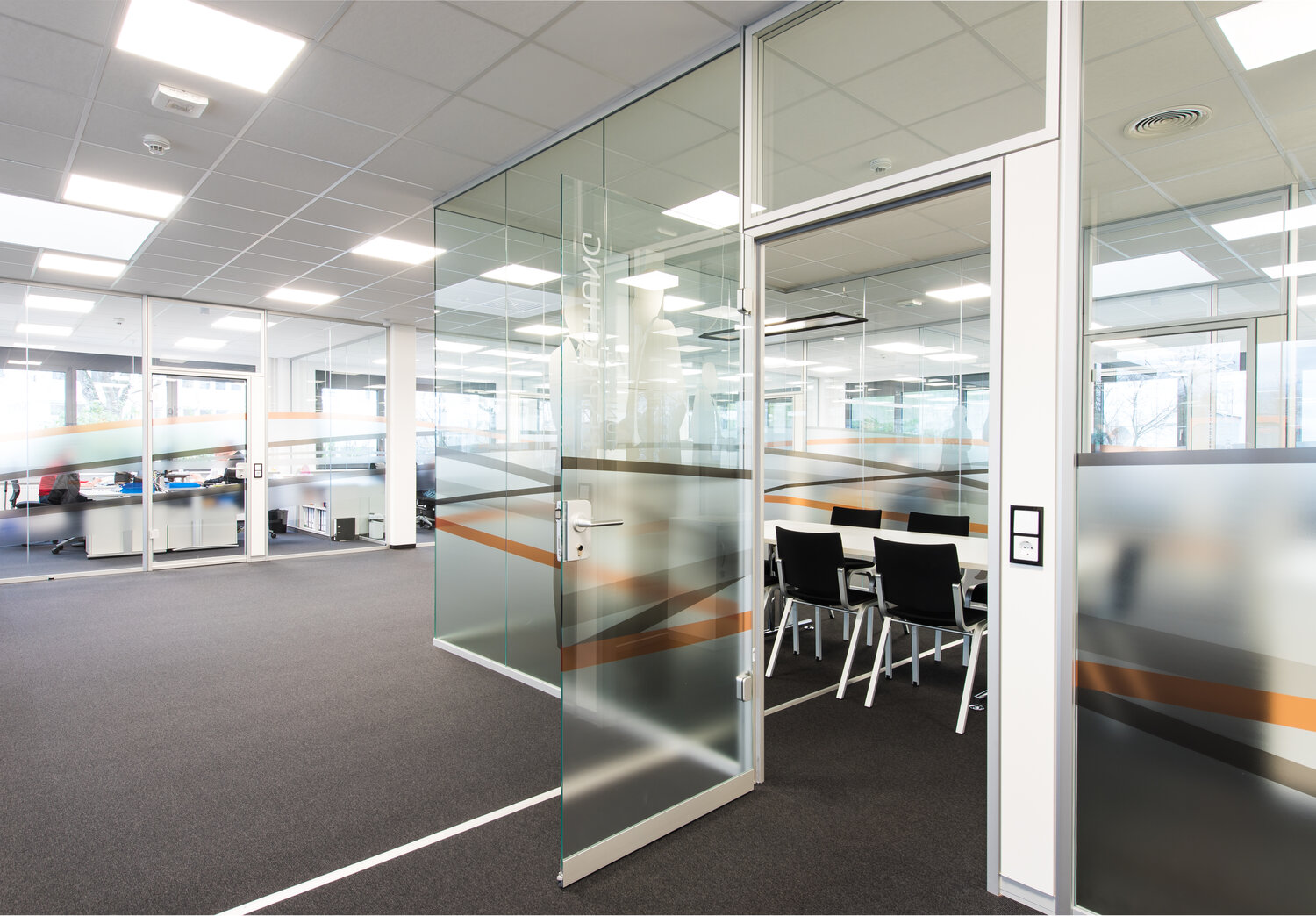 Projekt Buerkle Blick in Büro mit individuell folierten Glastrennwandsystemen